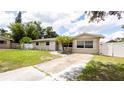 Charming single-story home featuring a well-maintained lawn, tidy landscaping, and a light beige exterior paint at 5300 Locksley Ave, Orlando, FL 32810