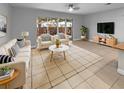 Bright living room with neutral tones, modern furnishings, and sliding glass doors to outdoor area at 576 Prospect Pt, Oviedo, FL 32765