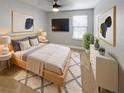 Serene bedroom with a plush bed, modern decor, and a flat-screen television for relaxation at 576 Prospect Pt, Oviedo, FL 32765
