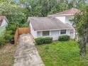 An aerial view of a quaint single-story home featuring well-maintained landscaping, and a concrete driveway at 809 Sugar House Blvd, Port Orange, FL 32129