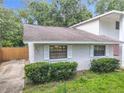 An aerial view of a quaint single-story home featuring well-maintained landscaping, and a concrete driveway at 809 Sugar House Blvd, Port Orange, FL 32129