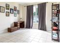 Neutral living room with tiled floors, large window, and decorative furnishings at 1021 Jaybee Ave, Davenport, FL 33897