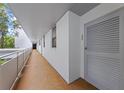 Hallway with door number 206 on a white wall. A long corridor with a metal railing at 1100 S Orlando Ave # 206, Maitland, FL 32751