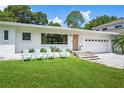 The attractive home features a well maintained front lawn with decorative chairs and front entry at 2102 Ivanhoe Rd, Orlando, FL 32804