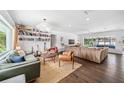 Spacious living room with hardwood floors, a large sectional sofa, and modern decor at 2102 Ivanhoe Rd, Orlando, FL 32804