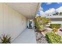Inviting front entrance with a well-lit walkway, complemented by lush landscaping and decorative touches at 2356 Date Palm Dr, Edgewater, FL 32141