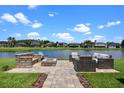 Outdoor patio with comfortable seating area and tranquil lake views in the background at 2451 Ridgemoor Dr, Orlando, FL 32828
