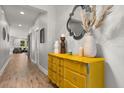 Inviting hallway featuring a stylish yellow dresser and modern decor accents at 31924 Geoff, Sorrento, FL 32776