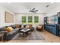 Cozy living room with a sectional sofa, modern fan, and bright natural light at 31924 Geoff, Sorrento, FL 32776