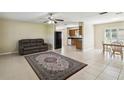 Inviting living room with tiled floor, a ceiling fan and an open floor plan at 3226 Midnight Star Ct, Kissimmee, FL 34744