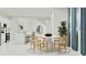 Open dining area offers a round table with seating adjacent to the kitchen at 349 Sol Vista Dr, Dundee, FL 33838