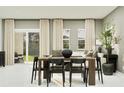 Inviting dining area featuring a modern table, stylish chairs, and bright natural light at 373 Sol Vista Dr, Dundee, FL 33838