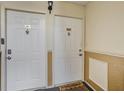 Condominium entrance featuring a welcome mat, two white doors with door knockers and unit numbers at 3997 Versailles Dr # 3997F, Orlando, FL 32808