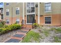Exterior shot of a condominium complex with multi-level architecture, neutral tones, and well-kept landscaping at 3997 Versailles Dr # 3997F, Orlando, FL 32808
