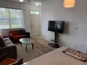 Inviting living room featuring a neutral color scheme, comfortable sofas, and ample natural light at 4002 San Gallo Dr # 105, Kissimmee, FL 34741