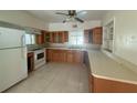 Functional kitchen with ample counter space, classic cabinetry, and an electric range oven at 5527 Sandalwood Dr, Orlando, FL 32839