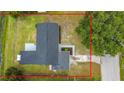 Aerial view of the home showcasing the roof, backyard, and surrounding landscape with mature trees at 609 Brockway Ave, Orlando, FL 32807