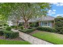 Well-maintained home with manicured lawn, mature trees, and a brick facade at 641 Virginia Dr, Winter Park, FL 32789