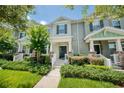 Inviting two-story townhouse with fresh landscaping and a welcoming front porch at 8164 Wood Sage Dr, Winter Garden, FL 34787