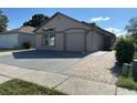 Attractive single-story home featuring a two-car garage, and a nicely paved driveway, with some mature landscaping at 8258 Golden Chickasaw Cir, Orlando, FL 32825