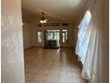 Spacious living area with tile floors, access to an outdoor patio, and neutral walls ready for your personal touch at 8258 Golden Chickasaw Cir, Orlando, FL 32825