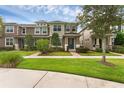Beautiful townhome with a well-kept lawn, brick walkway, and meticulously maintained landscaping at 8968 Hildreth Ave, Orlando, FL 32832