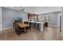 Spacious kitchen features stainless steel appliances, a center island with barstool seating, and ample countertop space at 8968 Hildreth Ave, Orlando, FL 32832