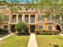 Inviting townhouse with a well-manicured lawn, tidy landscaping, and charming front porches at 9997 Town Lake Dr, Orlando, FL 32832