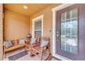Inviting front porch with comfortable seating, perfect for enjoying the outdoors with guests at 9997 Town Lake Dr, Orlando, FL 32832