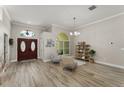 Inviting foyer with wood-look tile flooring and decorative lighting fixture at 10254 Hart Branch Cir, Orlando, FL 32832