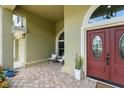 Charming covered front porch with stone flooring and double entry door at 10254 Hart Branch Cir, Orlando, FL 32832