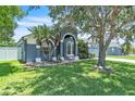 Charming single-story home featuring a manicured lawn, arched entryway and an attached two-car garage at 1031 Seneca Trl, St Cloud, FL 34772
