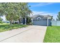 Charming single-story home featuring a manicured lawn, arched entryway and an attached two-car garage at 1031 Seneca Trl, St Cloud, FL 34772