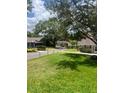 Scenic view of a quiet neighborhood street lined with mature trees and well-maintained lawns at 1034 Villa Ln # 18, Apopka, FL 32712