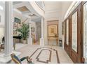 Grand foyer with high ceilings, tile floors, detailed trim and elegant staircase at 10915 Emerald Chase Dr, Orlando, FL 32836
