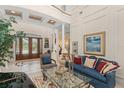 Elegant living room with soaring ceilings, tile floors, and luxurious furnishings at 10915 Emerald Chase Dr, Orlando, FL 32836
