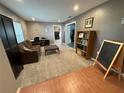 Cozy living room featuring a mix of wood and carpet flooring and neutral color scheme at 1140 Odoniel S Loop, Lakeland, FL 33809