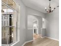 Open dining room with hardwood floors, chandelier, and views of the kitchen at 13658 Hidden Forest Cir, Orlando, FL 32828