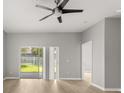 Spacious living room with sliding glass doors, hardwood floors, and ceiling fan at 13658 Hidden Forest Cir, Orlando, FL 32828