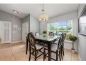 Bright dining area with a modern chandelier, stylish table set, and large window offering natural light at 14301 Bending Branch Ct, Orlando, FL 32824