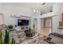 Comfortable living room featuring a modern entertainment center and plush seating with neutral tones at 14301 Bending Branch Ct, Orlando, FL 32824