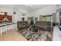 Inviting living room with dual reclining couches, high ceilings, bar seating, and lots of natural light at 14301 Bending Branch Ct, Orlando, FL 32824