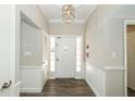 Bright foyer featuring modern lighting, wood-look floors, and wainscoting at 1481 Glastonberry Rd, Maitland, FL 32751