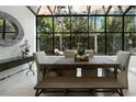 Sunlit dining room with a large window, natural wood table, bench seating, and neutral decor at 1769 Turnberry Ter, Orlando, FL 32804
