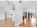 Spacious open floor plan with wood floors, light walls, and natural light at 204 Grovepark Dr, Davenport, FL 33837