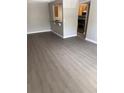 Open-concept layout featuring a bar area between the kitchen and living room, enhanced by stylish gray flooring at 2065 Dixie Belle Dr # O, Orlando, FL 32812