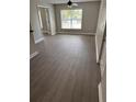Bright living room featuring attractive gray flooring, a ceiling fan, and natural light at 2065 Dixie Belle Dr # O, Orlando, FL 32812