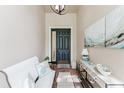 Welcoming foyer with a tiled floor, bench seating, console table, and a decorative light fixture at 2173 Caledonian St, Clermont, FL 34711