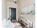 Inviting foyer featuring a dark front door, decorative artwork, stylish console table and attractive accents at 2173 Caledonian St, Clermont, FL 34711