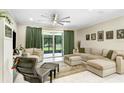 Spacious living room with a large sectional sofa and access to the screened patio at 2491 Wadeview Loop, St Cloud, FL 34769